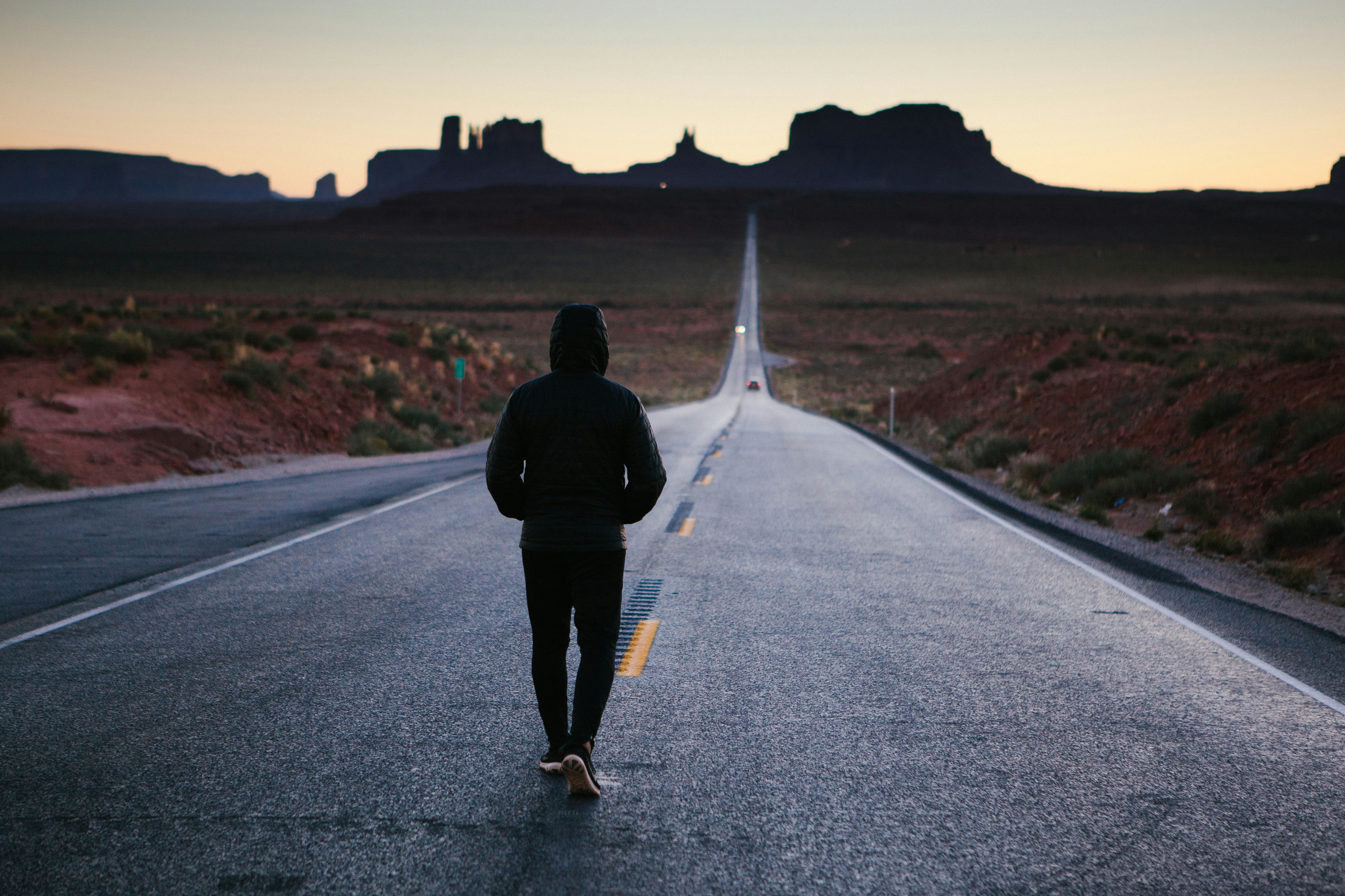 person walking in the center of the road